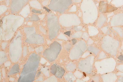 Grey-white marble aggregate chips are highlighted with a luxurious coral-peach cement base to provide a unique tonal composition.