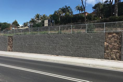 The retaining wall and shared path at Mount Kembla, NSW, features Baines Masonry's Split Face Block retaining wall system.