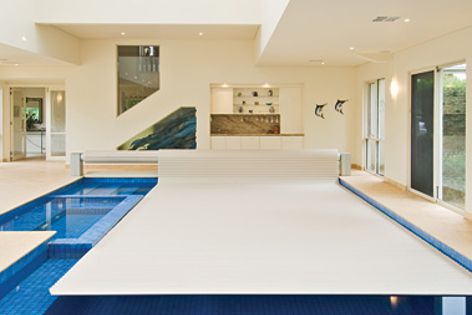 The Sunbather Security Blanket is a safe and attractive addition to this indoor swimming pool.