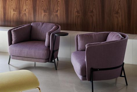 Stylish and comfortable Cradle armchairs have curved sides that embrace the sitter.