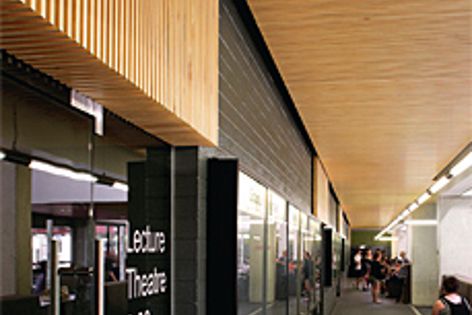 Solid timber slats with acoustic textile backing are used to create Screenwood panels.